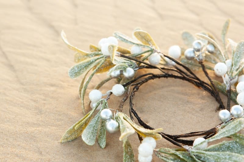 mistletoe ornament, glittered, placed on sand