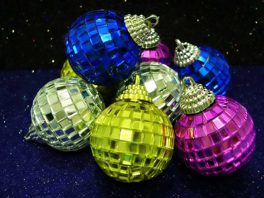 Pink, blue and yellow lying flasks, reminiscent of disco balls.