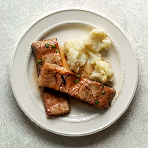 black carp on plums and cauliflower garnish