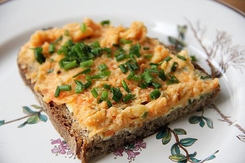 Bread spread with horseradish spread with carrots and chives