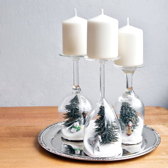 Candlestick for the Christmas table made of wine glasses with motifs of a snowy landscape