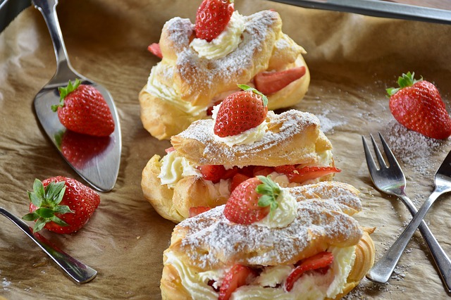 Decorating Christmas cookies with cream and strawberries.