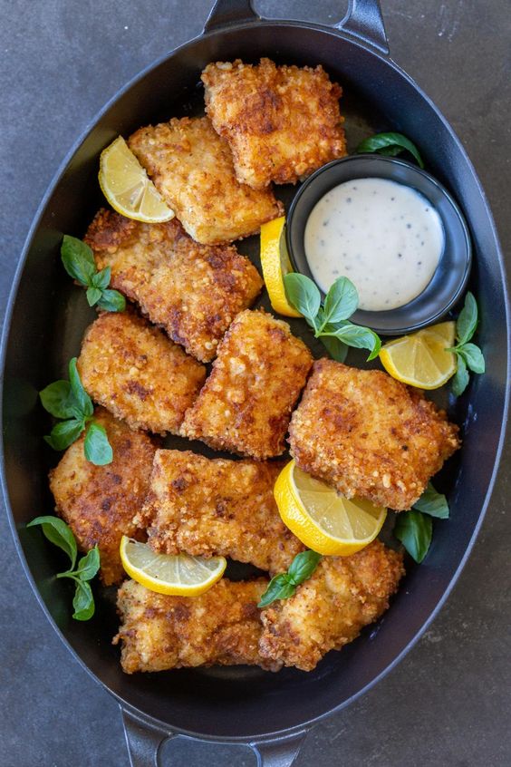 Oven-baked tender carp fries in a baking dish.