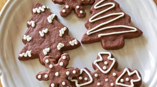 Decorated chocolate gingerbread in the shape of stars and a tree.