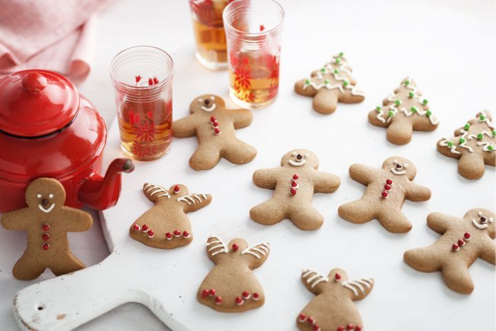 Traditional Christmas gingerbread in the shape of figures and trees, decorated with colored icing.