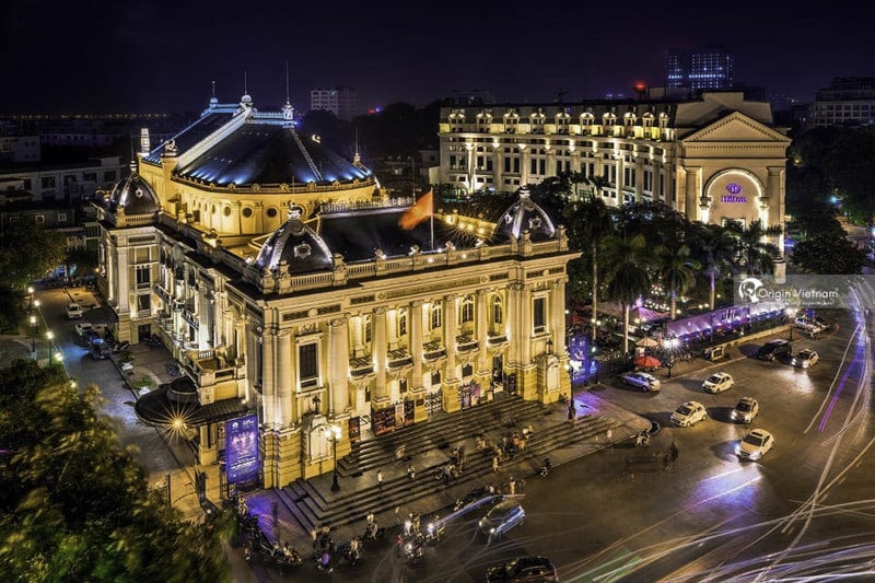 The Hanoi Opera House, which is beautifully lit for a nighttime production.