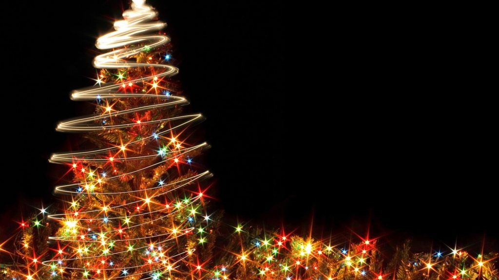 Colorful glowing Christmas tree on a black background.