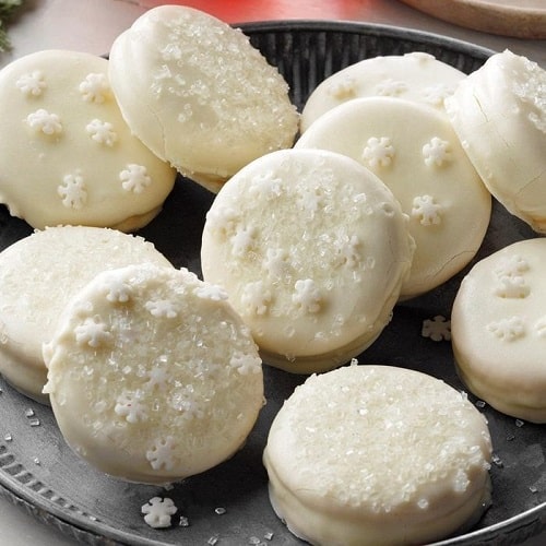 Biscuits dipped in lemon glaze decorated with sprinkles in the shape of flakes