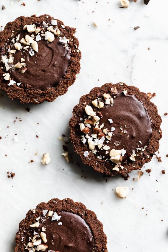 Sweet chocolate cupcakes with hazelnuts as decoration.