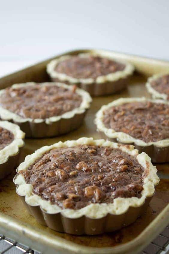 Small cupcakes with walnuts in a mold.