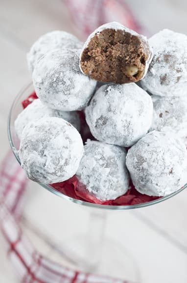 Christmas rum balls covered in icing sugar.