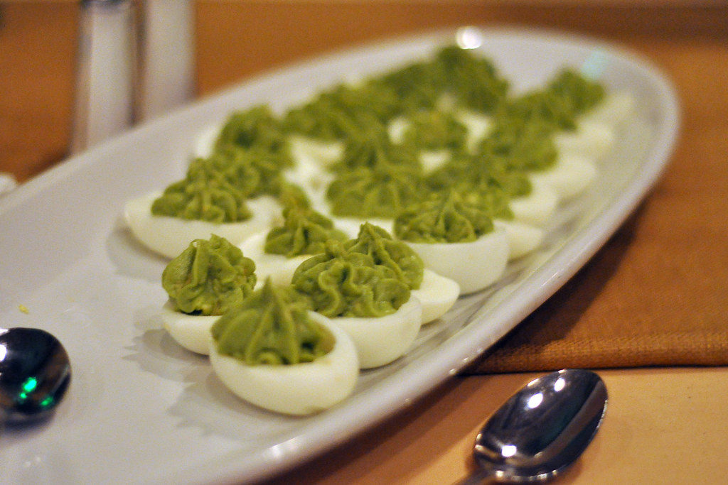 Halved eggs with avocado cream filling