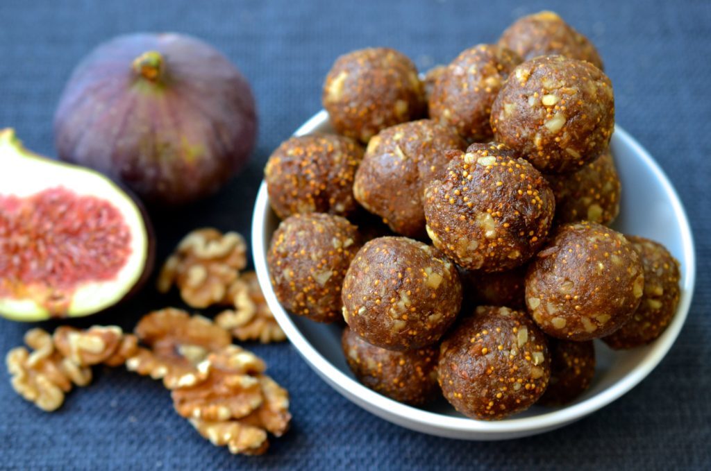 Unbaked fig cookies in the shape of balls in a bowl.