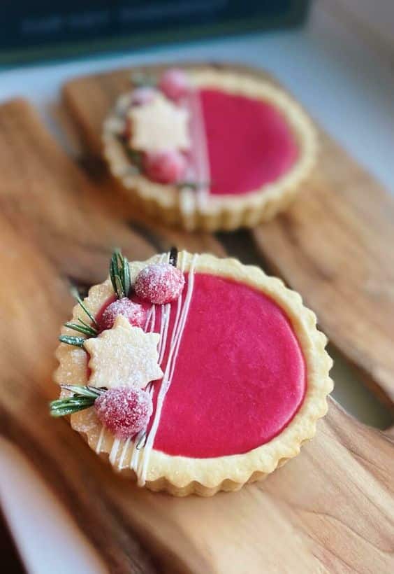 Sweet cupcakes with pink cranberry filling, beautifully decorated.