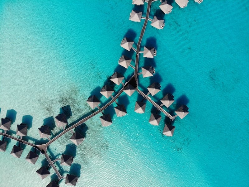 Floating huts on the clear sea on the island of Bora Bora.