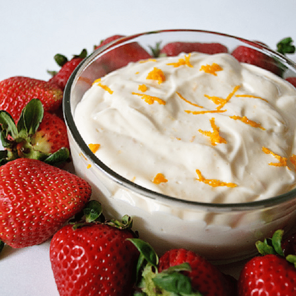 fruit cream in a bowl with strawberries around