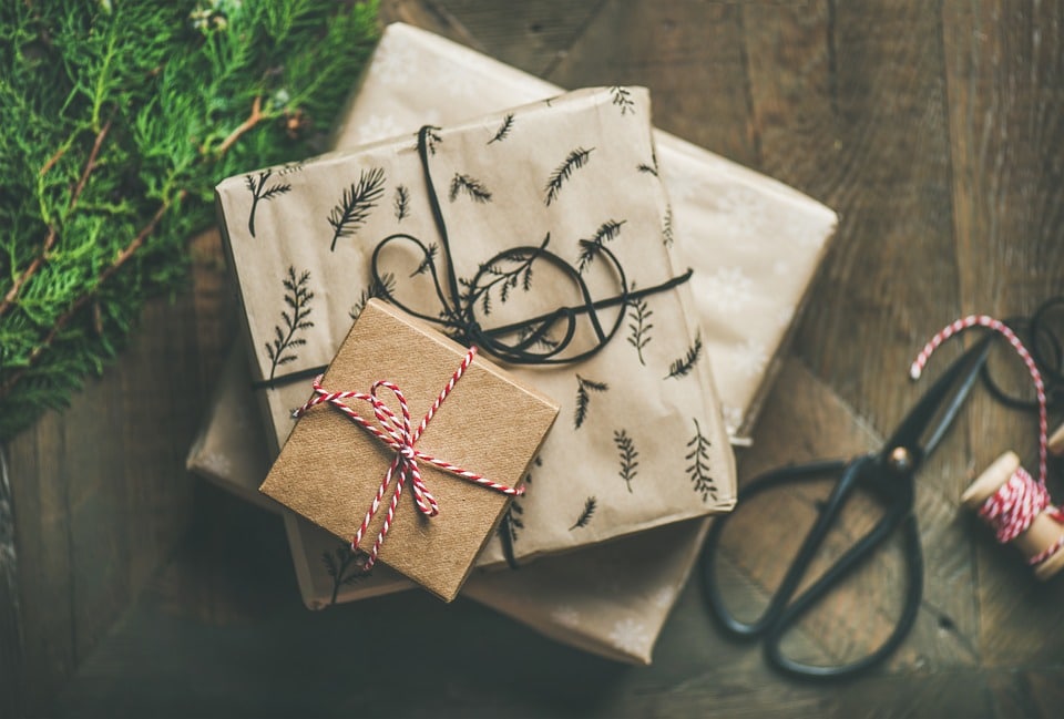 Top view of gifts wrapped in beige paper.