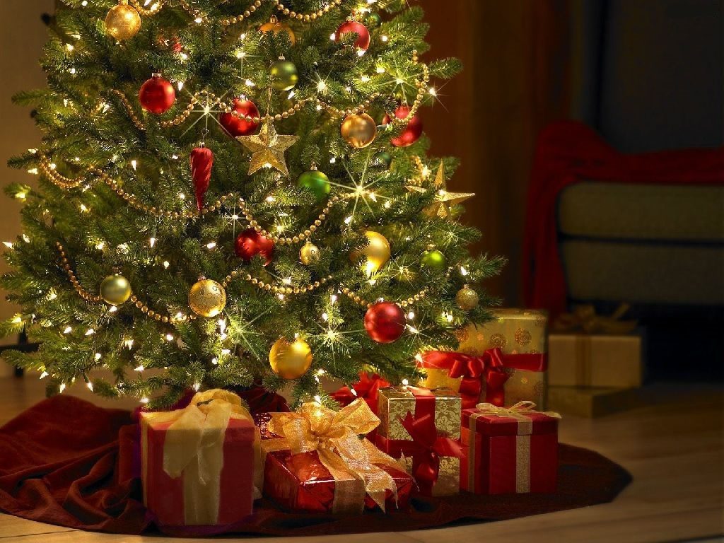 Greeting card with a Christmas picture of a decorated tree and red gifts tied with gold ribbons.