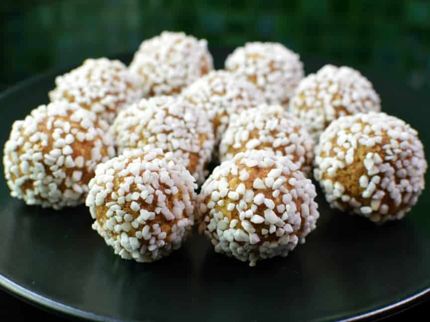 Unbaked balls of almond paste, butter, oatmeal and gingerbread covered in pearl sugar.