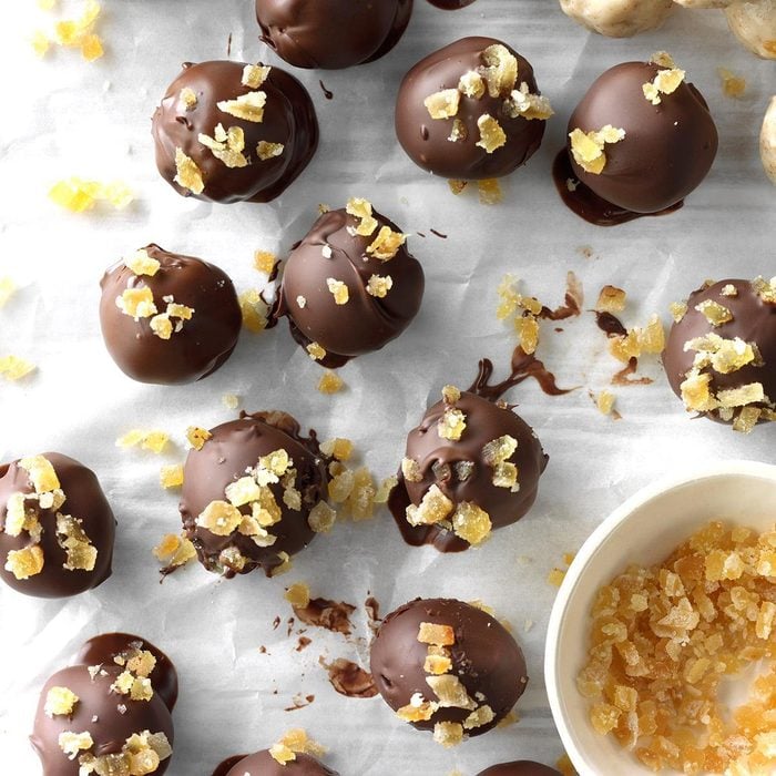 White chocolate balls wrapped in dark chocolate and decorated with candied ginger.