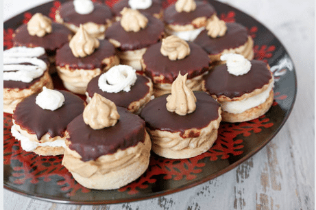 Glued walnut cookies with cream laid out on a plate.