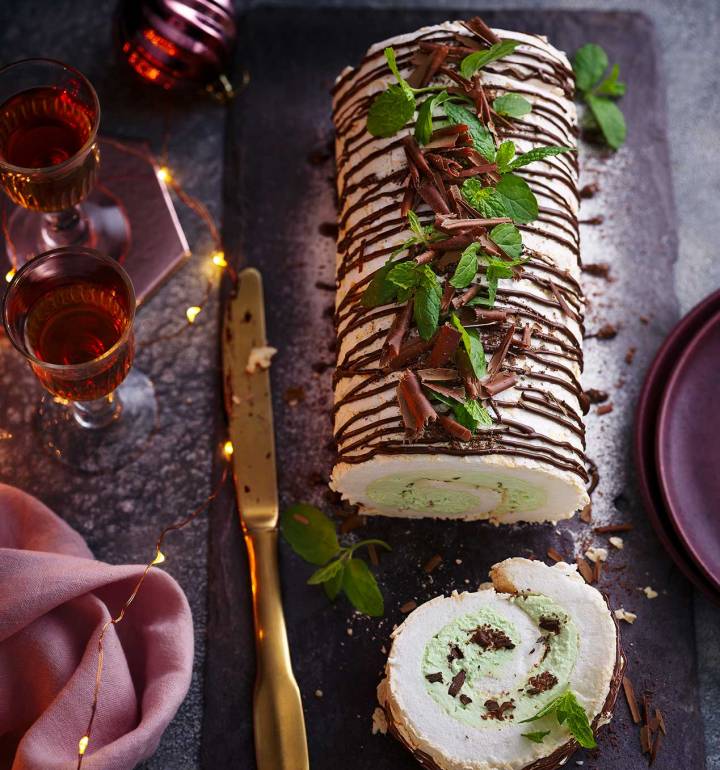 Gluten-free egg white roll with chocolate and mint with a knife next to it.