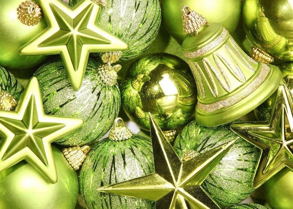 Postcard with green decorations in the shape of stars, balls and bells.