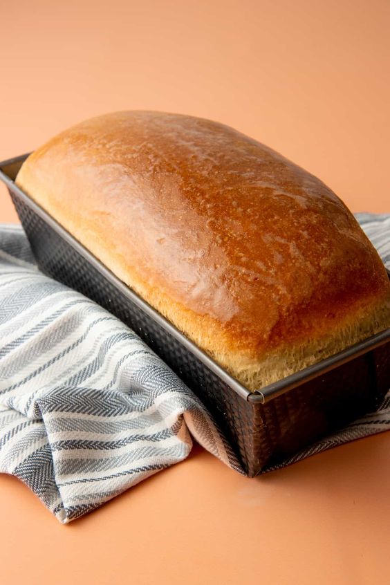 Baked bread with a golden crust in bread form.