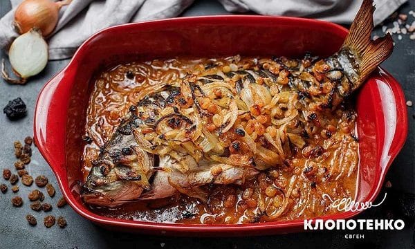 Jewish-style carp with onions and raisins in a baking dish