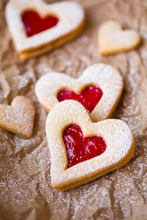 Line cookies for celiacs in the shape of hearts on baking paper