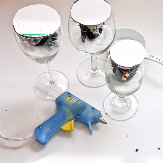 Making candlesticks from wine glasses - gluing ornaments using hot melt glue