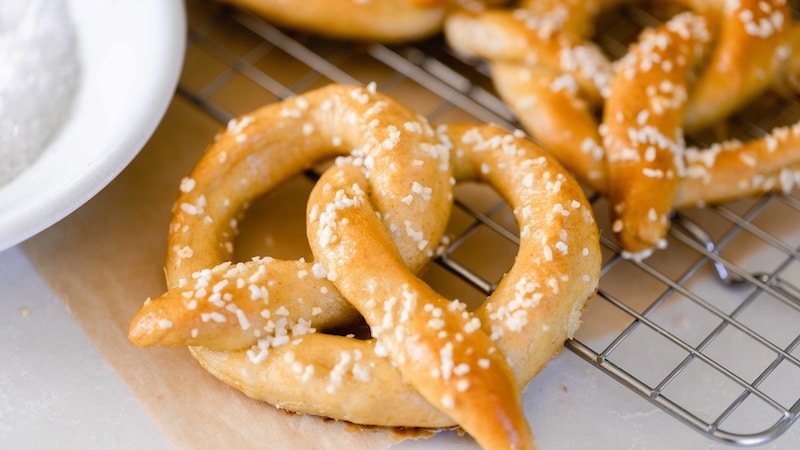 Beautiful homemade pretzels on the grill, sprinkled with coarse salt.