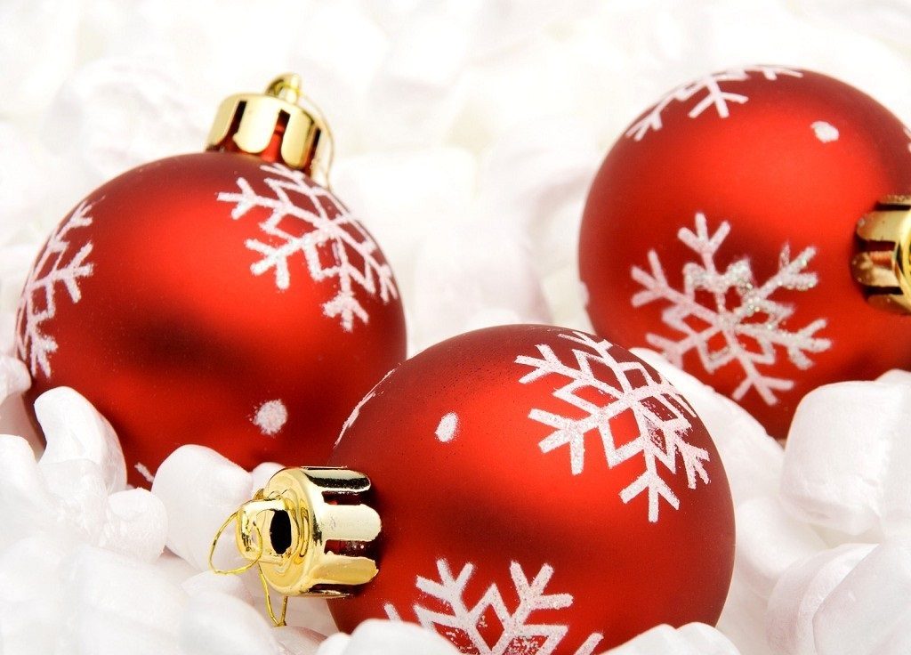 Christmas image with red lying flasks decorated with white snowflakes.