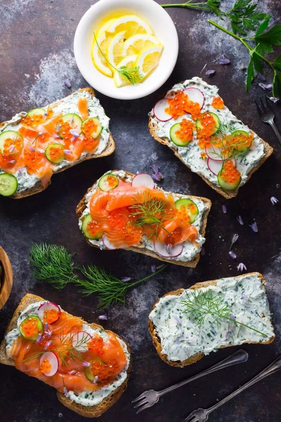 Perfectly decorated sandwiches with spread and smoked salmon.