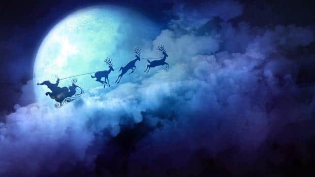 Violet-blue postcard with a view of clouds, the moon and Santa Claus in a sleigh pulled by three reindeer.