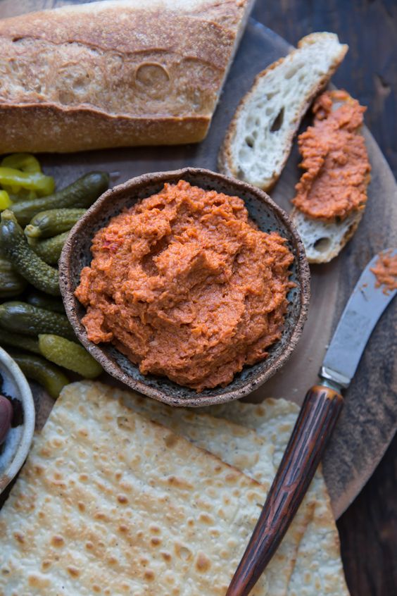 Bowl with salami spread and pickle.