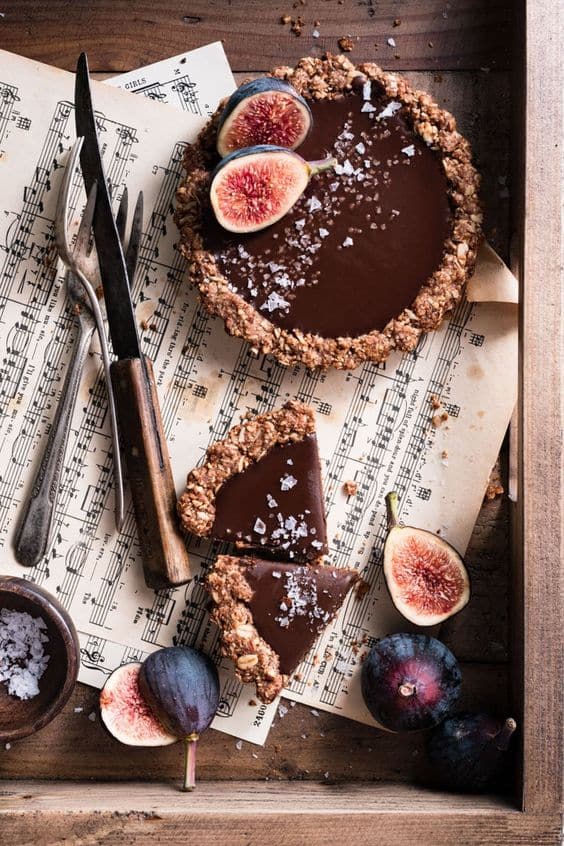 A sweet cupcake filled with chocolate cream and decorated with fresh figs.