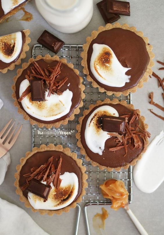 A cupcake filled with salted caramel and decorated with chocolate shavings.