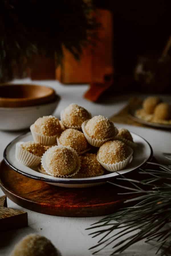 Honey balls in paper cups on a plate.