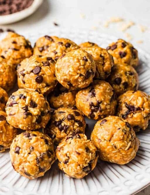 Oat balls with peanut butter, nuts, dried fruit and honey on a plate.