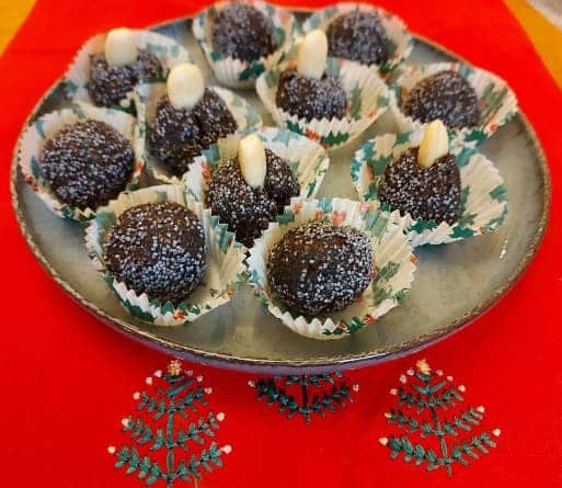 Poppy balls with almonds in paper cups.