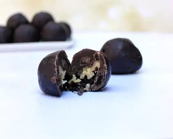 Balls made of chocolate, condensed milk and chocolate wafers filled with walnuts.