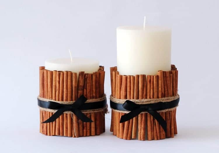 Vanilla candles with cinnamon as a decorative candle holder.