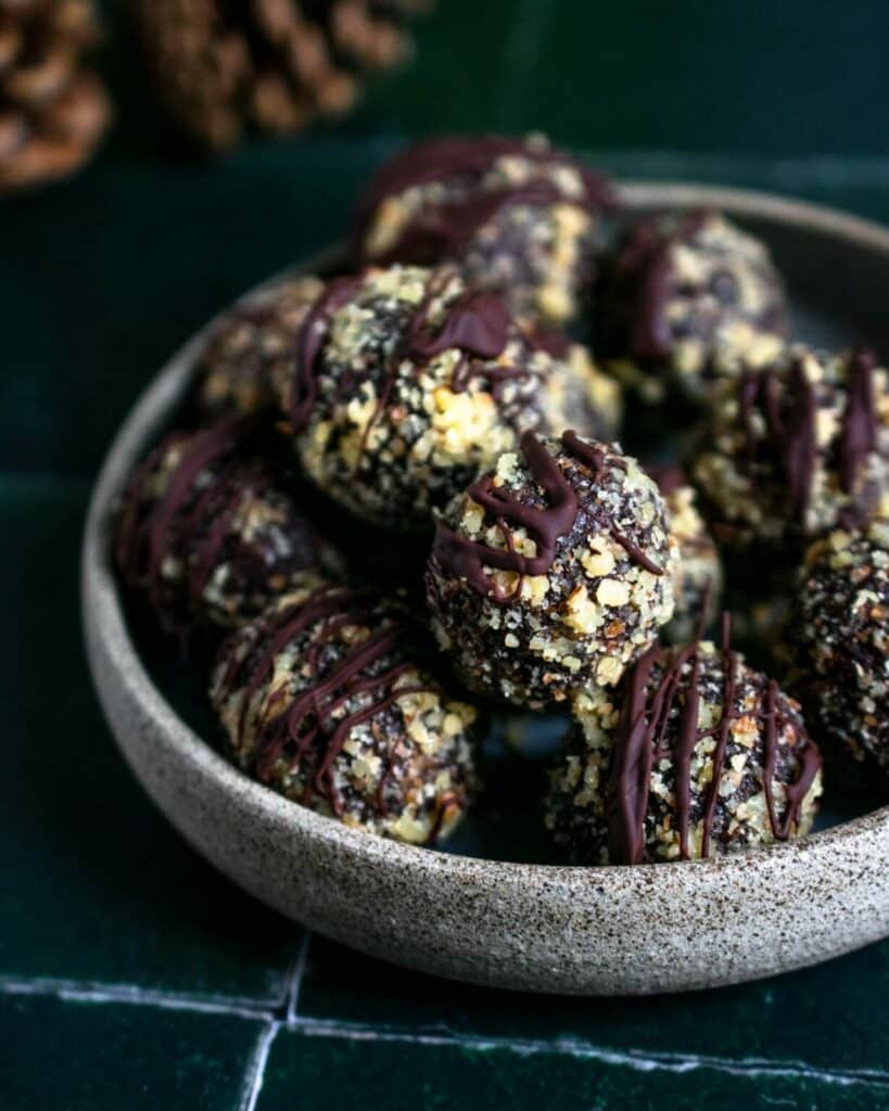 Balls with dates, nuts and chocolate in a bowl.