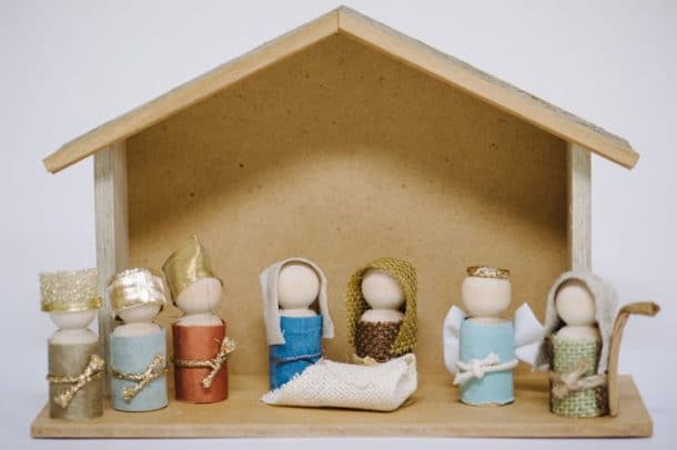 Another nativity scene made of wood including figurines.