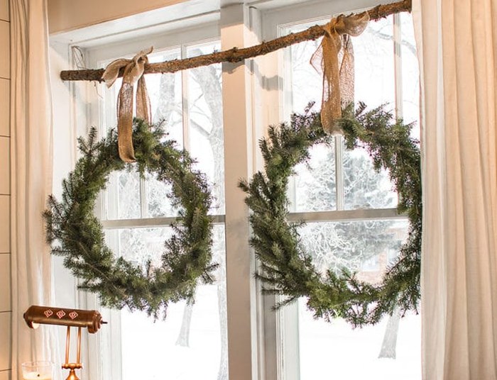 Two wreaths of branches on the window.