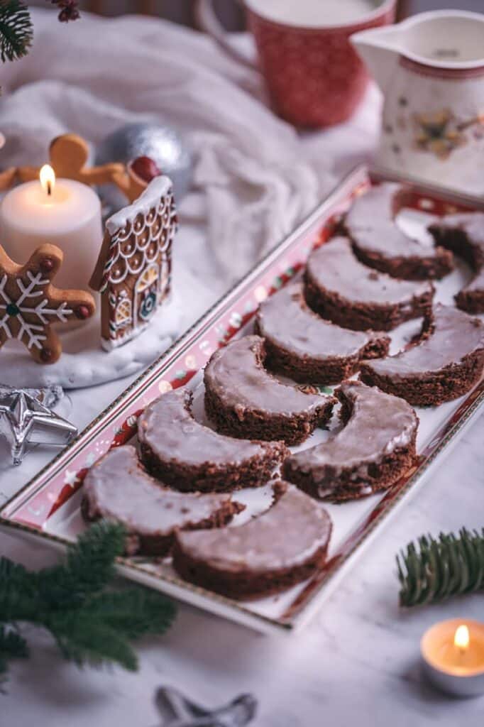 Butter rolls with chocolate and sugar coating on a tray.