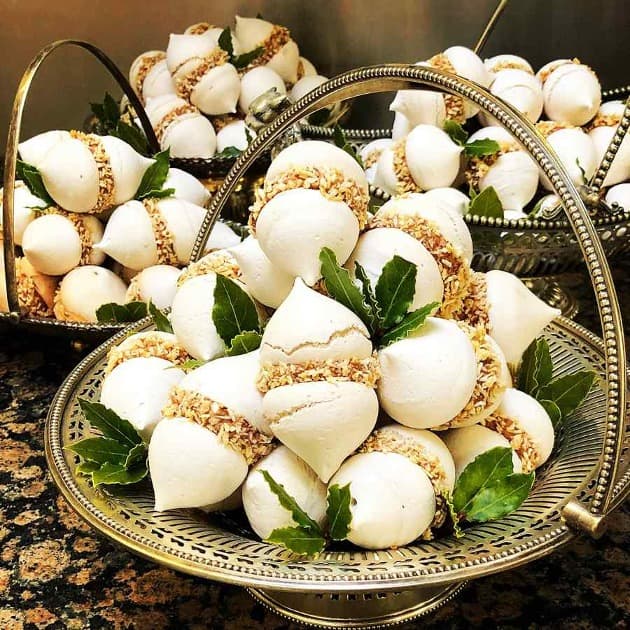 Tender meringues glued together with delicious chocolate cream and wrapped in homemade candied coconut.