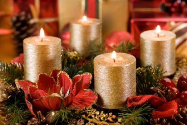 The Advent wreath with four candles, golden color, symbolizing the four weeks of Advent leading up to Christmas. Each candle represents one week of the Advent season, with one of the candles lit on the third Sunday to symbolize joy. The tradition of lighting the candles each week helps to count down and prepare for the celebration of Christmas.